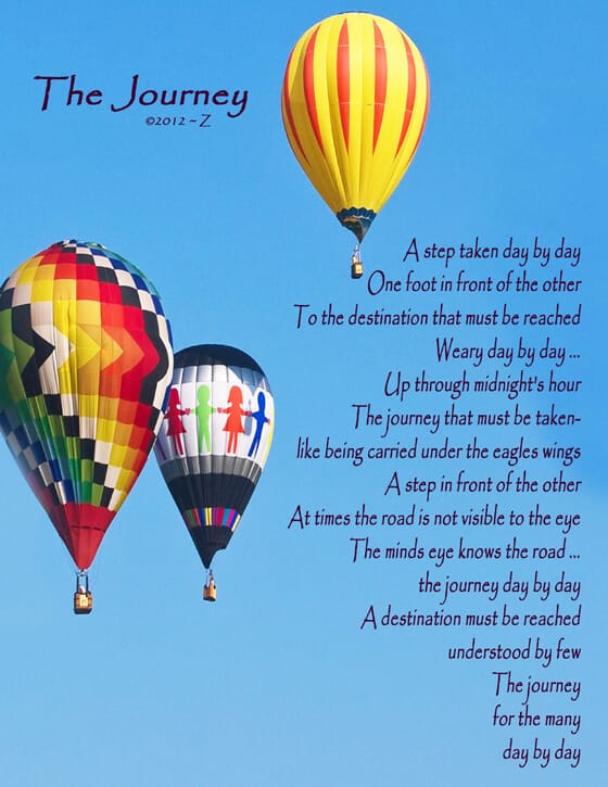 Three hot air baloons in a clear blue sky