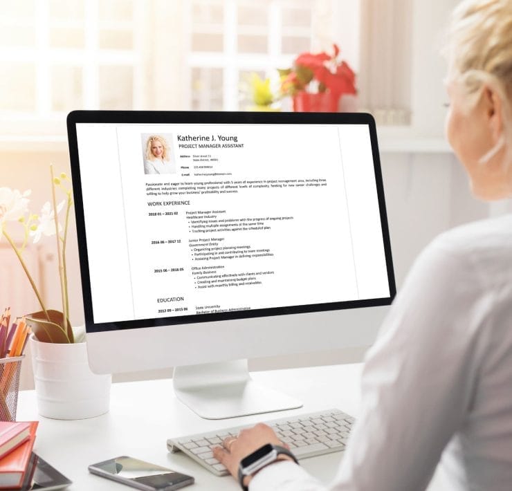 A person working on a computer learning more about client references